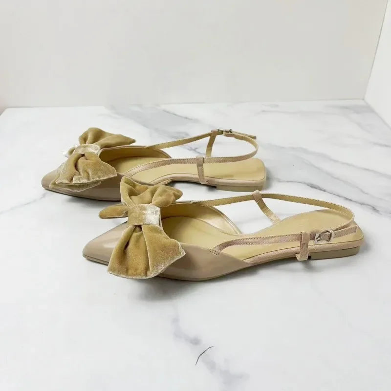 Light beige bow embellished exposed heel flat shoes